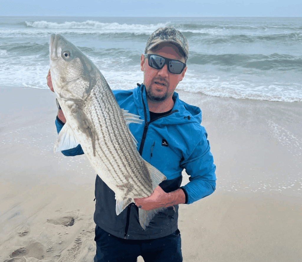 Erik Moritz (above) caught this striped bass off the south end surf fishing clam Sunday.